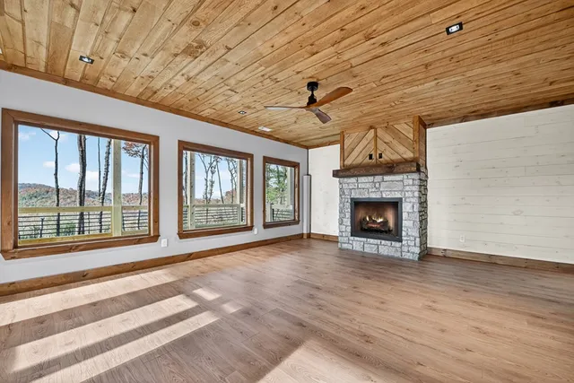 a view of a hallway with wooden floor and entryway