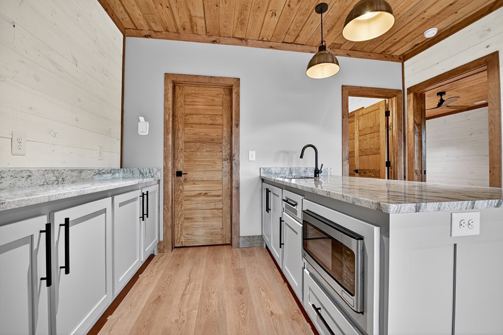 22 Mountain Trace Cherry Log, GA 30522 - Photo 39 of 49 a kitchen with granite countertop a sink cabinets stainless steel appliances and a granite counter tops