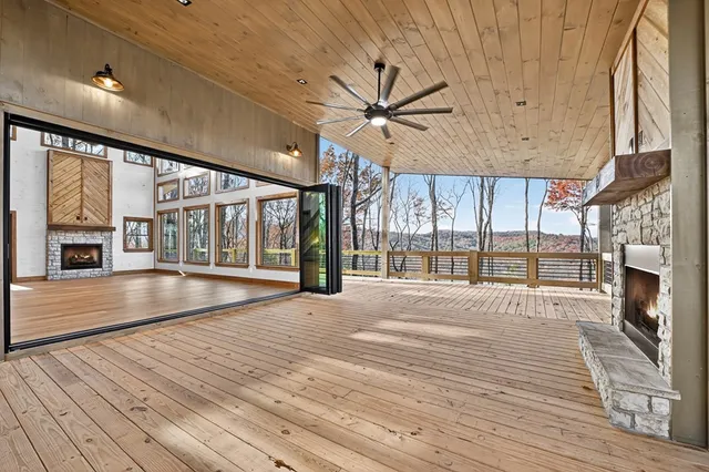 a kitchen with stainless steel appliances granite countertop a refrigerator a sink dishwasher a stove and white countertops with wooden floor