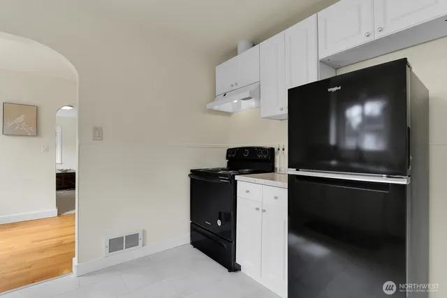 a kitchen with stainless steel appliances a stove microwave and refrigerator