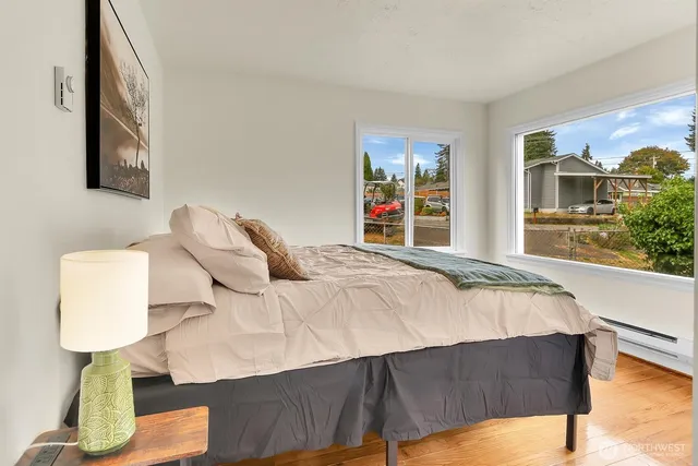 a bed sitting in a bedroom next to a window