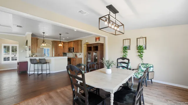 a view of a dining room with furniture wooden floor and chandelier