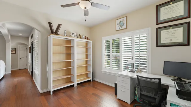 a view of a workspace with furniture and a window