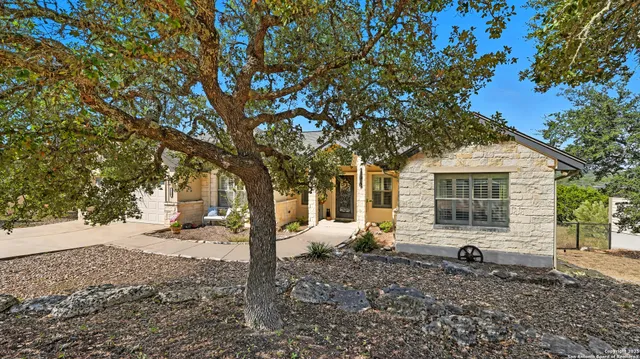 a backyard of a house with barbeque oven table and chairs