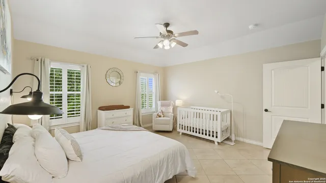 a bedroom with two beds and a window