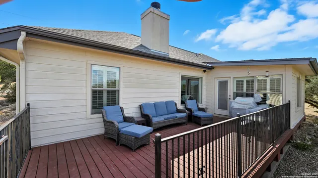 a view of roof deck with wooden floor and fence
