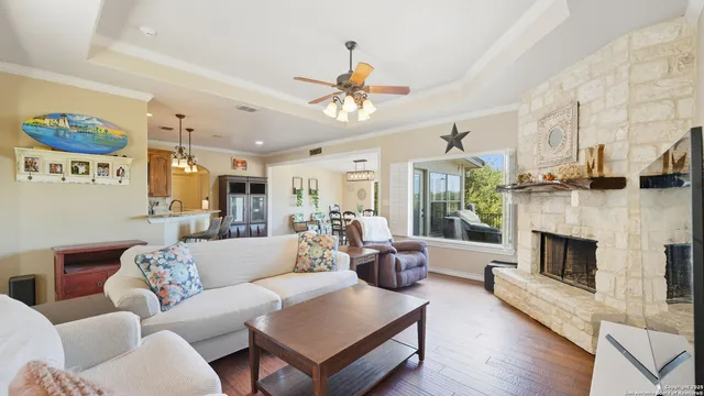 a living room with furniture a fireplace and a table