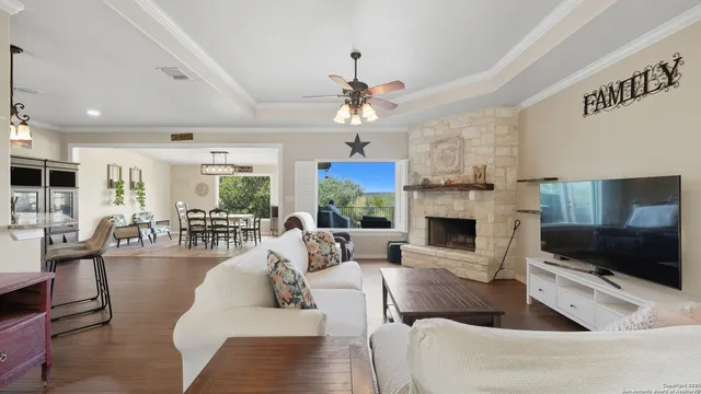 a living room with furniture a fireplace and a flat screen tv