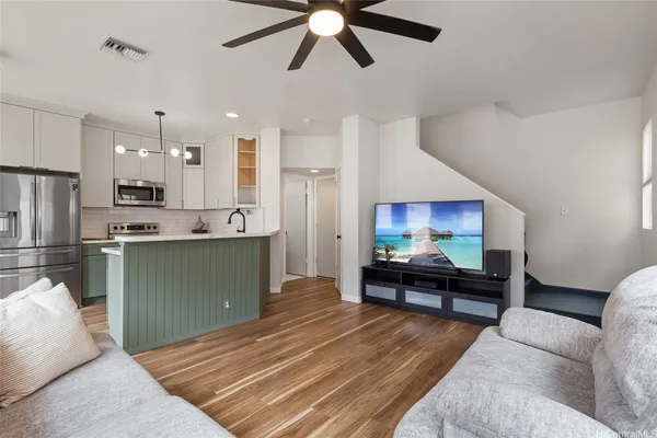 a living room with furniture and kitchen view