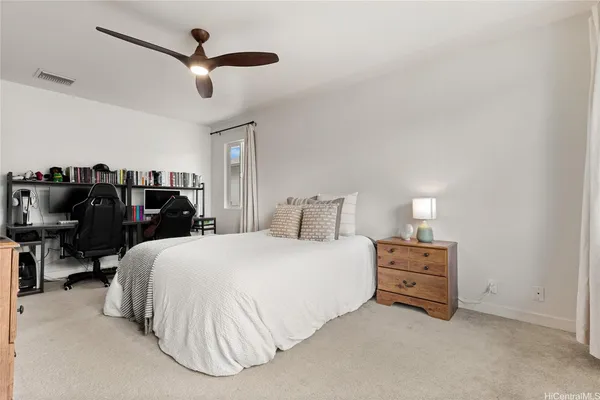 a bedroom with a bed a dresser and a window