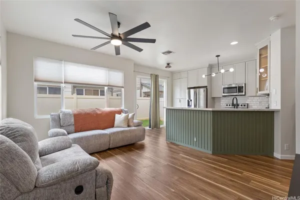 a living room with furniture and kitchen view