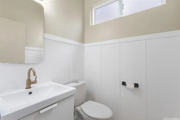 a bathroom with a sink a toilet and mirror