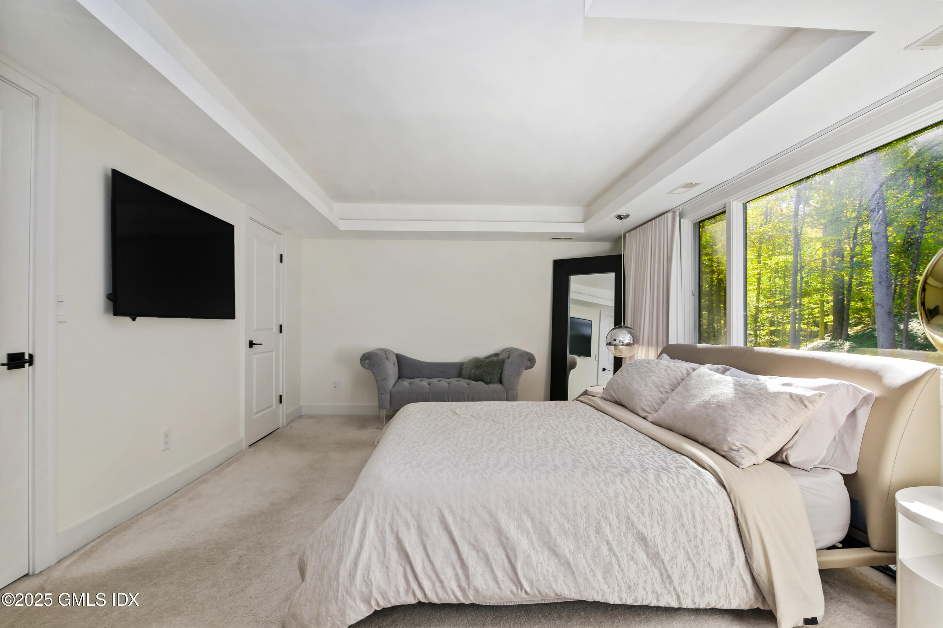 210 Red Fox Road Stamford, CT 06903 - Photo 12 of 25 a bedroom with a bed and a flat screen tv