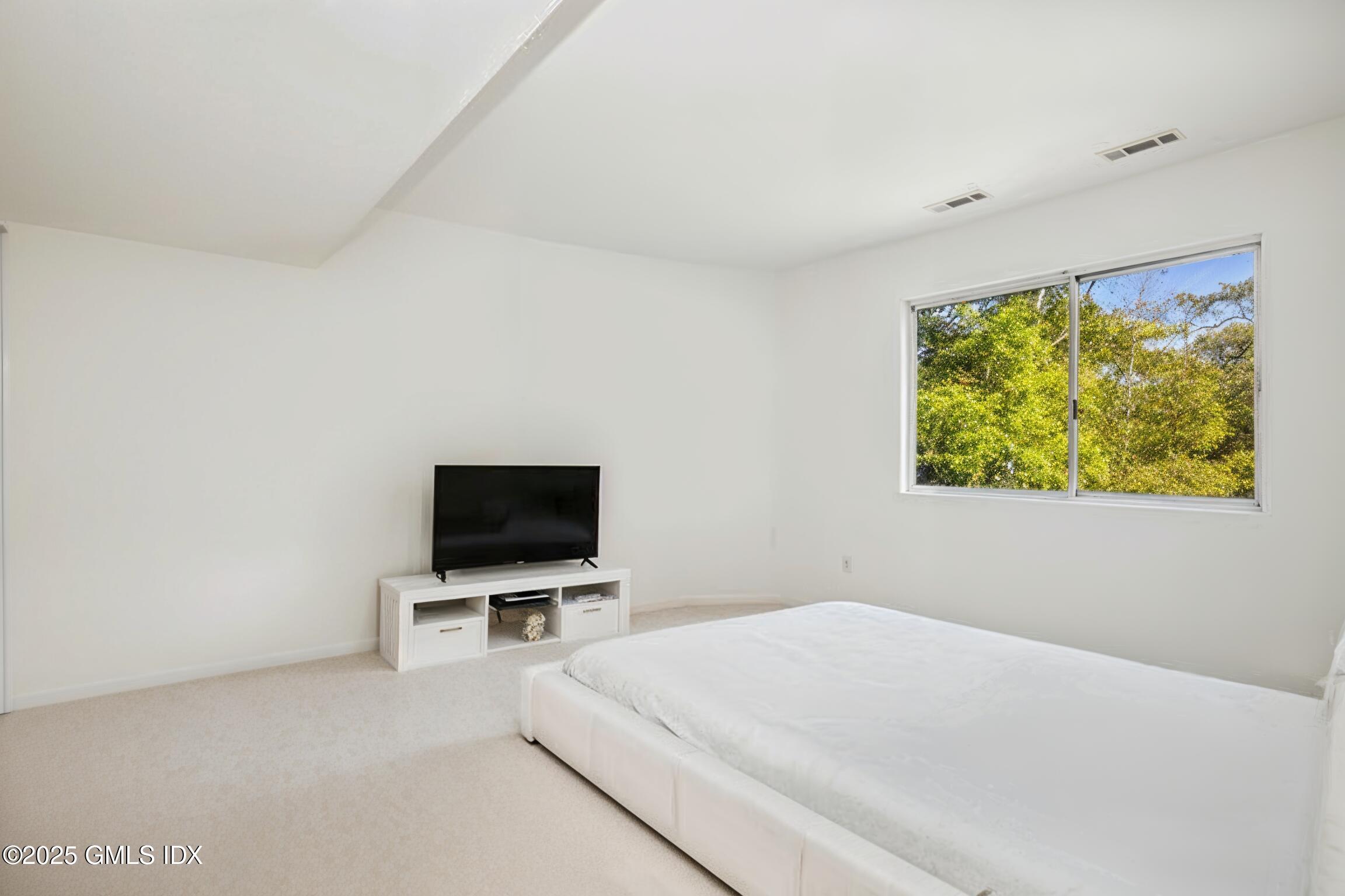 210 Red Fox Road Stamford, CT 06903 - Photo 15 of 25 a bedroom with a bed and a flat screen tv