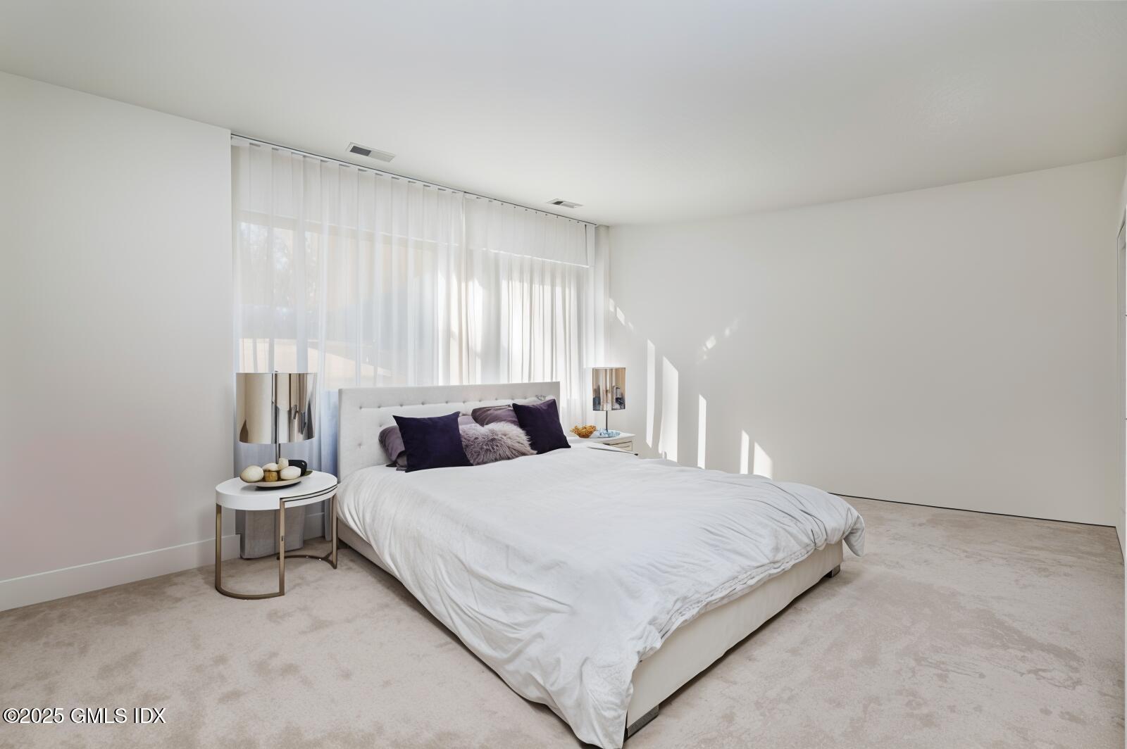 210 Red Fox Road Stamford, CT 06903 - Photo 16 of 25 a bedroom with a bed and a lamp