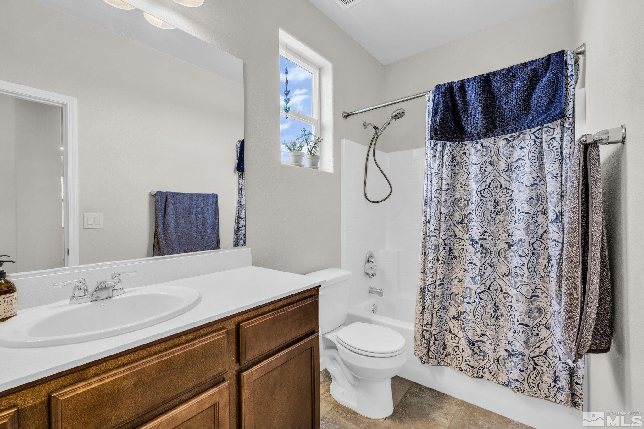 2215 Symphony Way Reno, NV 89521 - Photo 12 of 39 a bathroom with a granite countertop sink toilet and shower