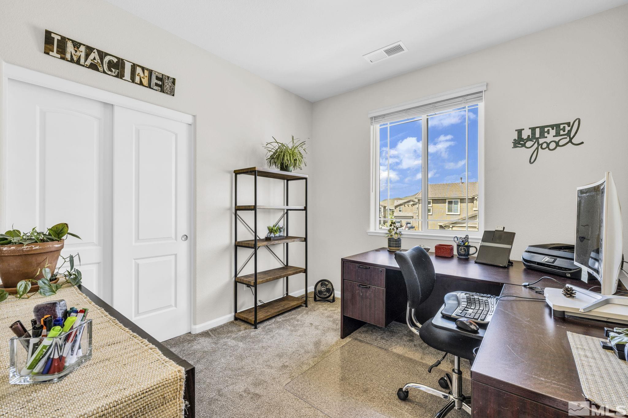 2215 Symphony Way Reno, NV 89521 - Photo 16 of 39 a view of a workspace with furniture and a window