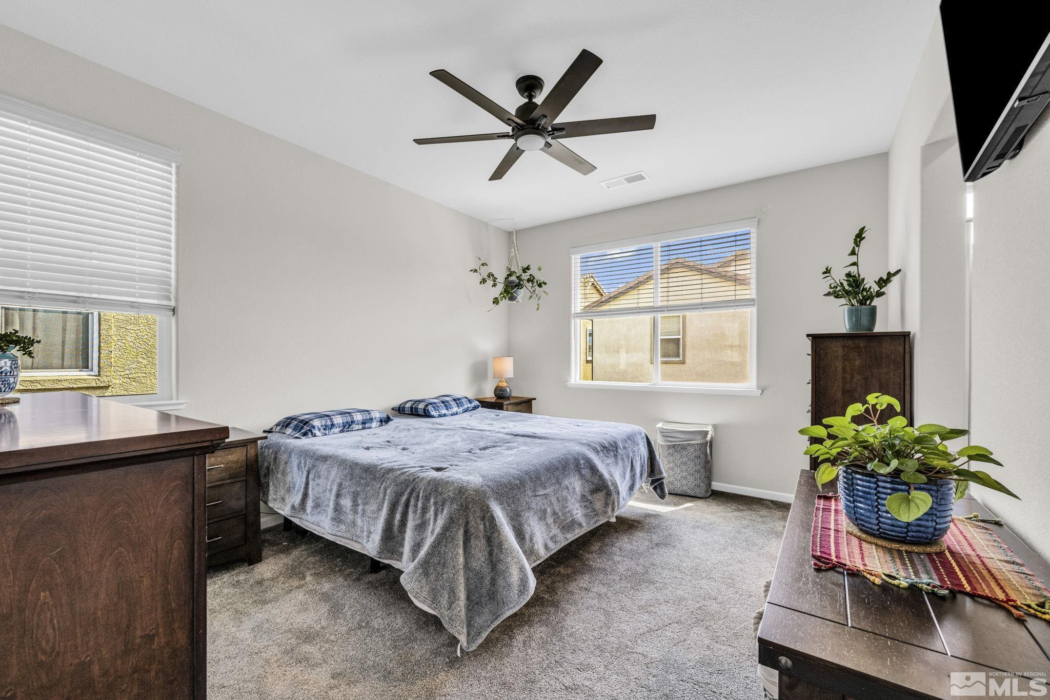 2215 Symphony Way Reno, NV 89521 - Photo 21 of 39 a bedroom with a bed table and a window