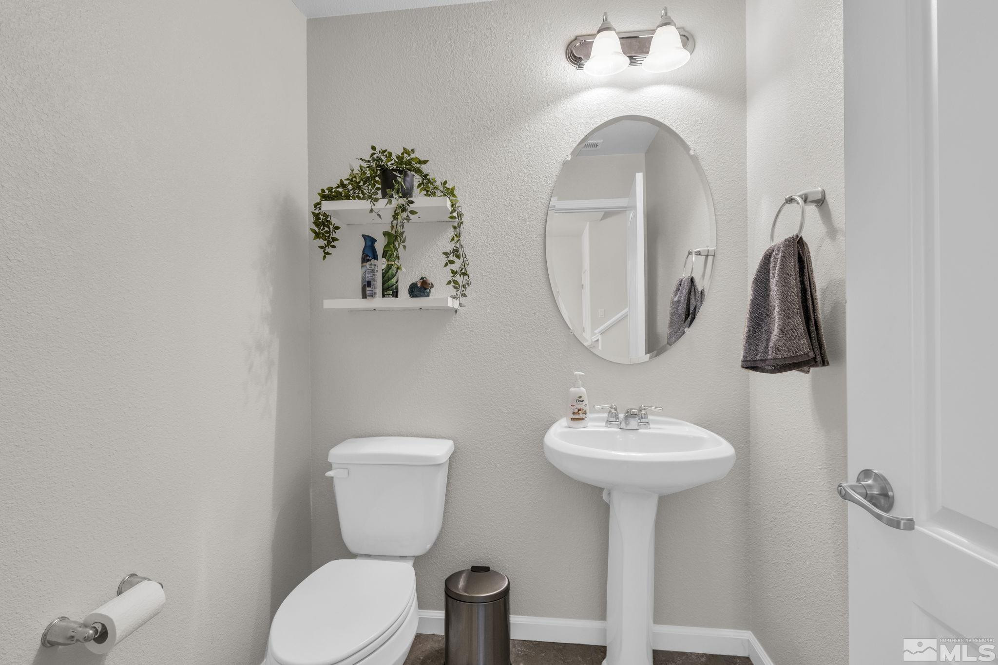 2215 Symphony Way Reno, NV 89521 - Photo 23 of 39 a bathroom with a toilet sink and mirror