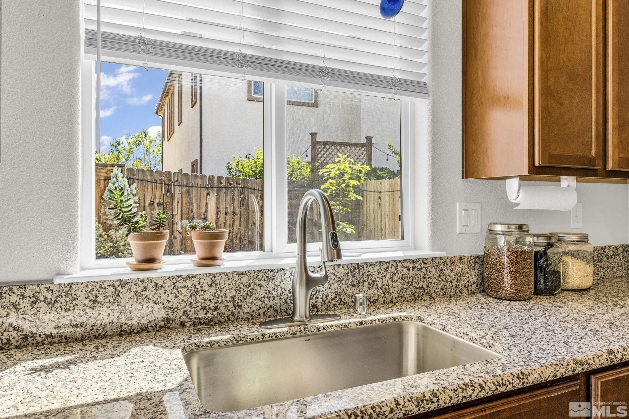 2215 Symphony Way Reno, NV 89521 - Photo 3 of 39 a kitchen with granite countertop a sink and a window