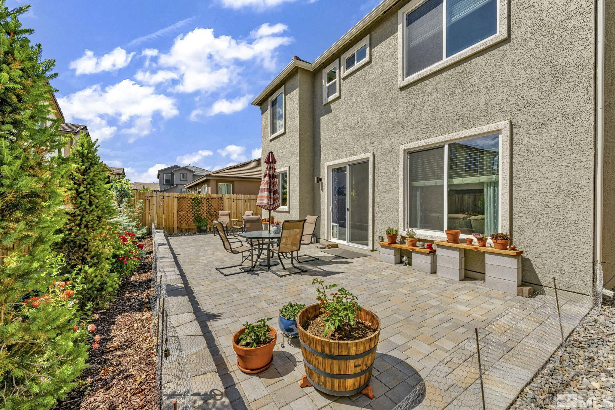 2215 Symphony Way Reno, NV 89521 - Photo 36 of 39 a view of a patio with table and chairs and potted plants