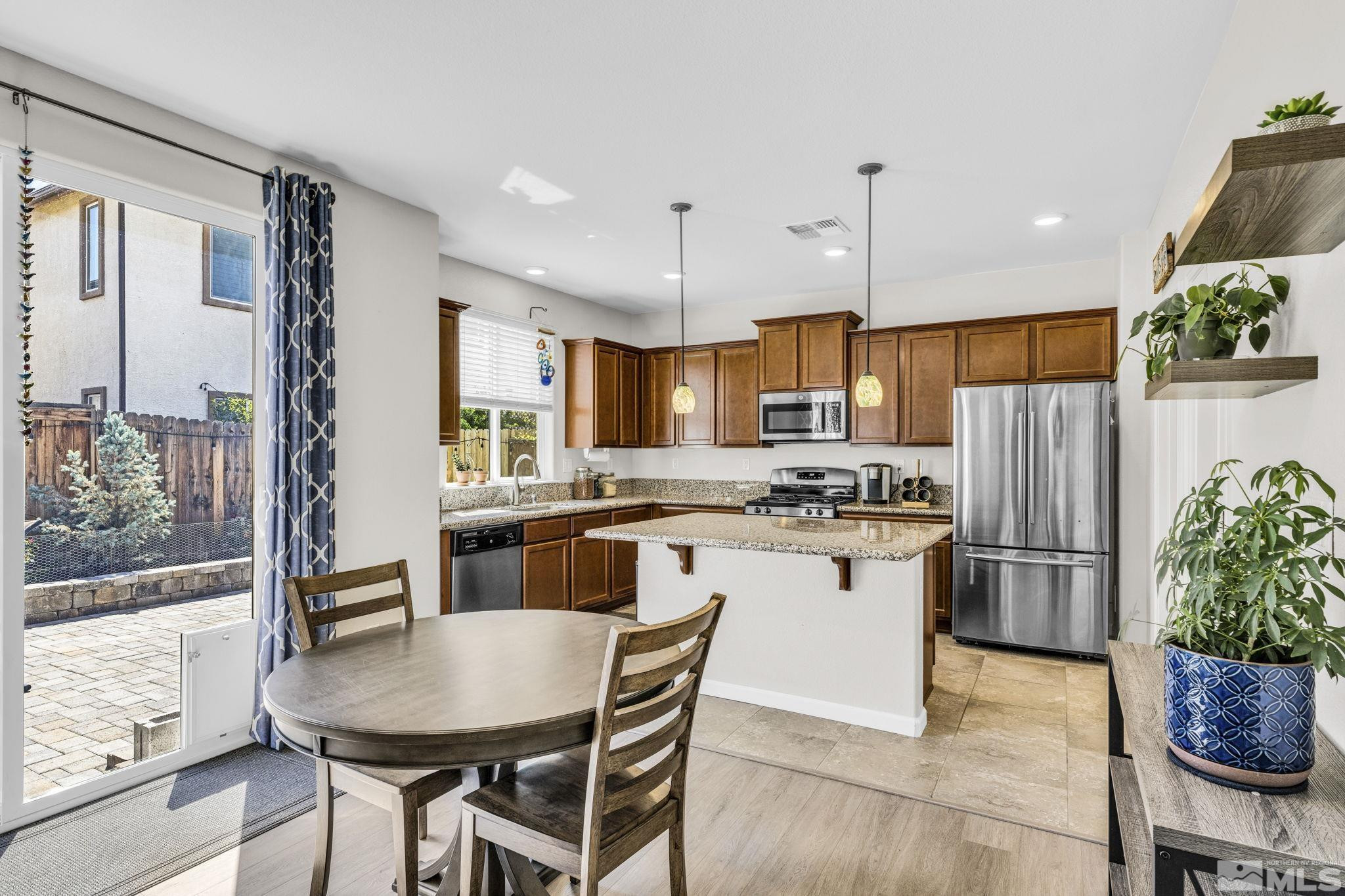 2215 Symphony Way Reno, NV 89521 - Photo 6 of 39 a kitchen with refrigerator and cabinets
