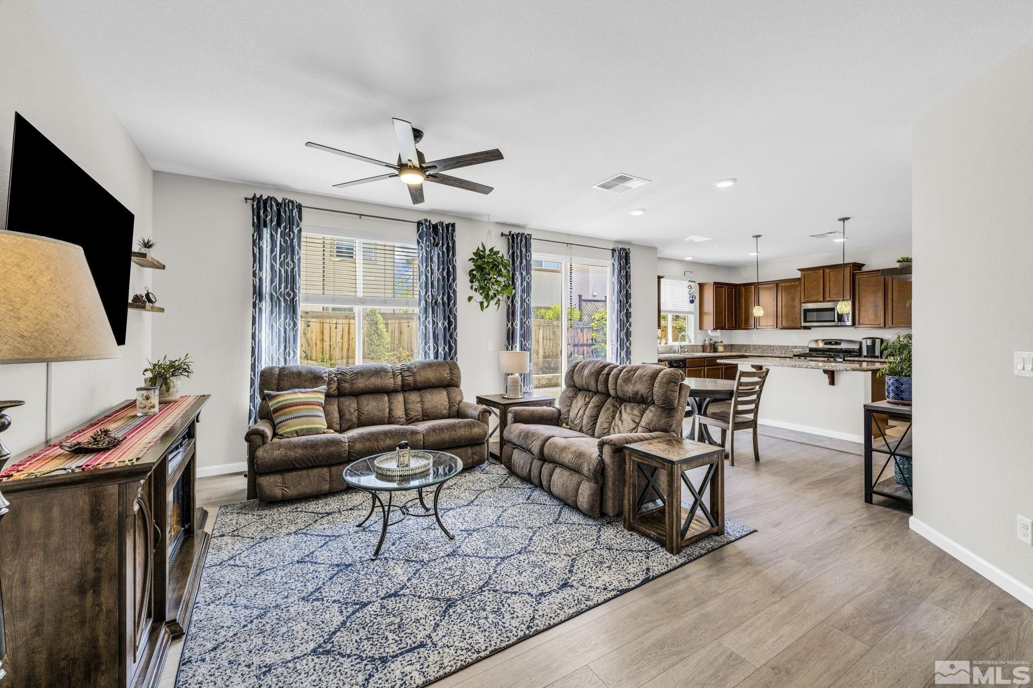 2215 Symphony Way Reno, NV 89521 - Photo 10 of 39 a living room with furniture flat screen tv and outdoor view