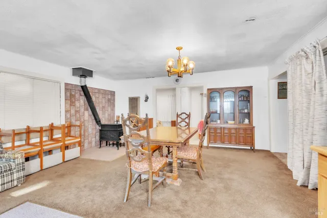 a view of a dining room with furniture and a chandelier