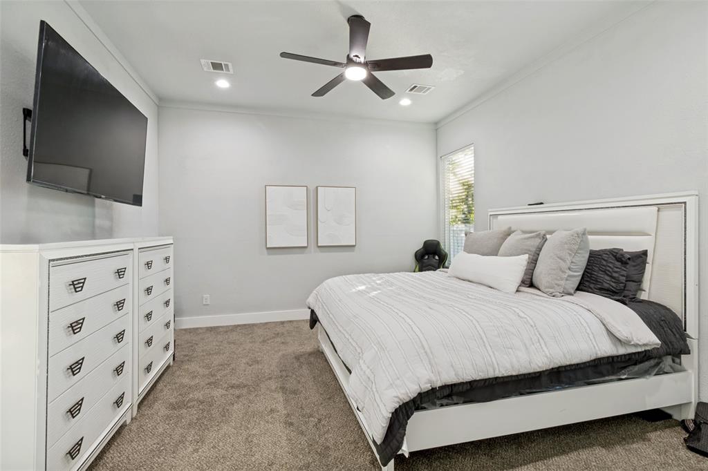 7909 Ivory Lane Dallas, TX 75216 - Photo 12 of 20 a bedroom with double bed and a flat tv screen on dresser