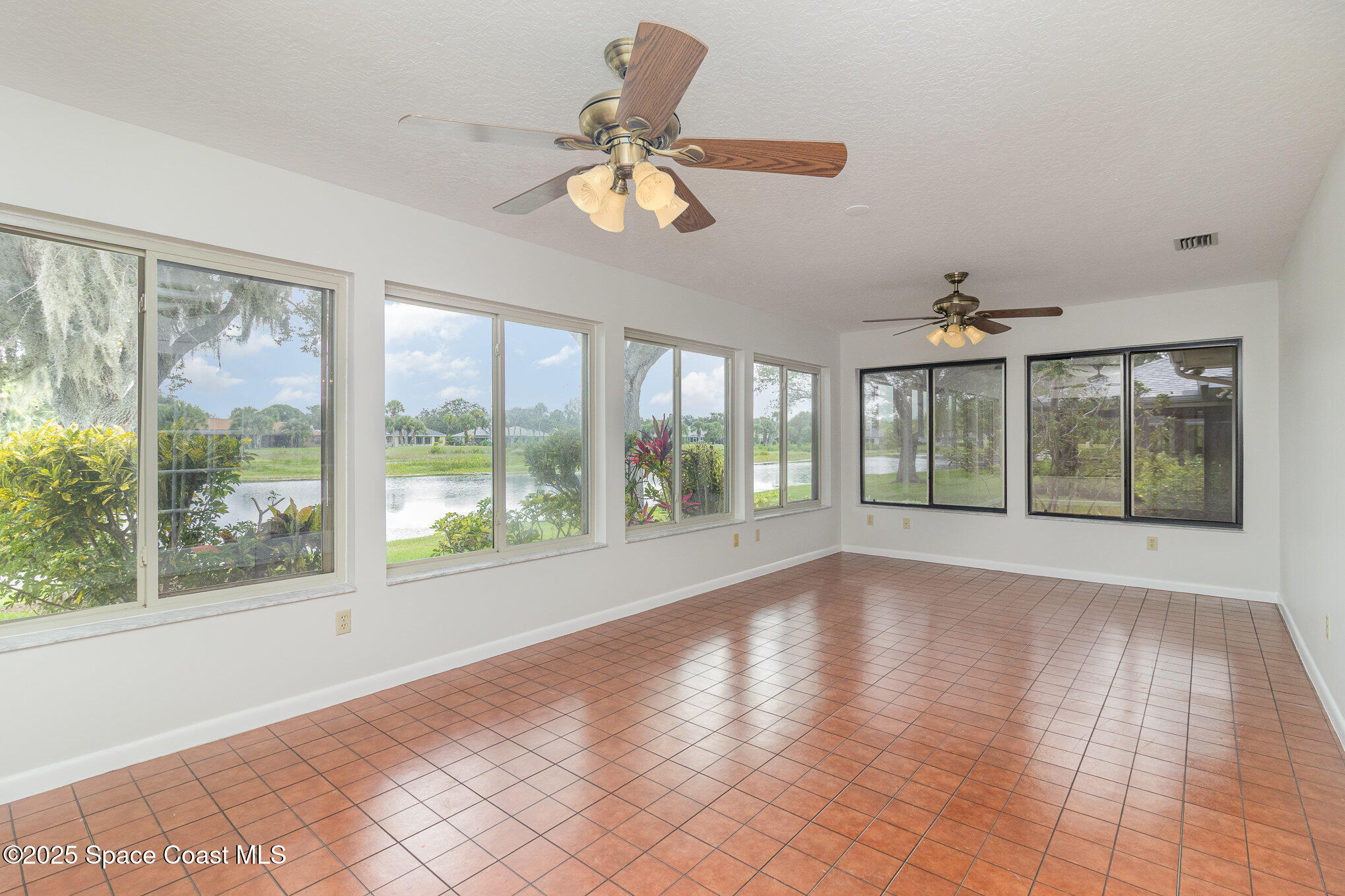 1570 Frontier Drive Melbourne, FL 32940 - Photo 12 of 43 a view of room with window and ceiling fan