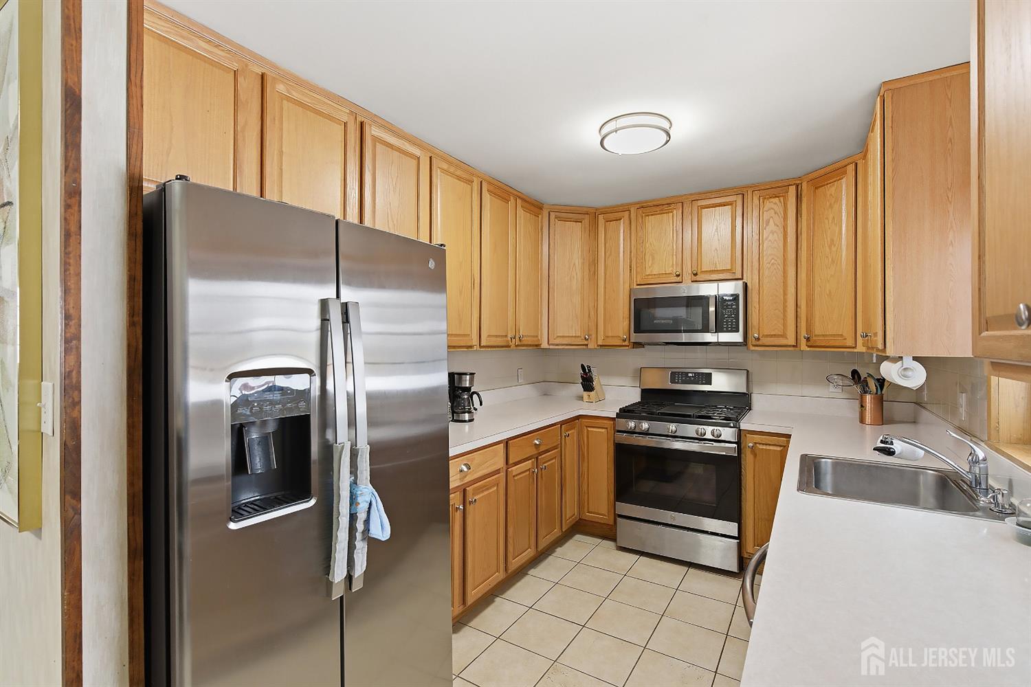 10 Cranston Road Kendall Park, NJ 08824 - Photo 12 of 27 a kitchen with stainless steel appliances granite countertop a refrigerator stove and sink