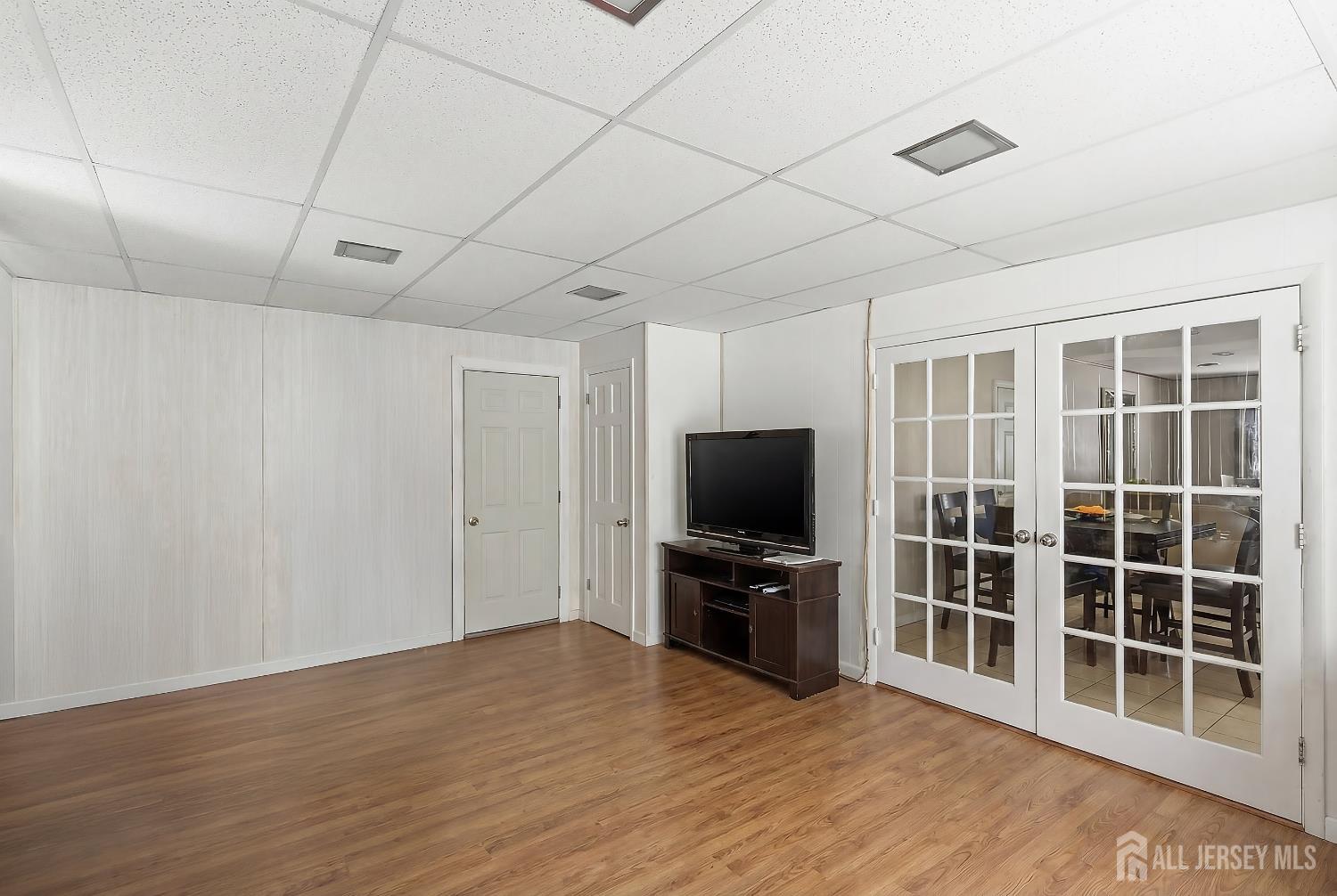 10 Cranston Road Kendall Park, NJ 08824 - Photo 13 of 27 a view of empty room with wooden floor and windows