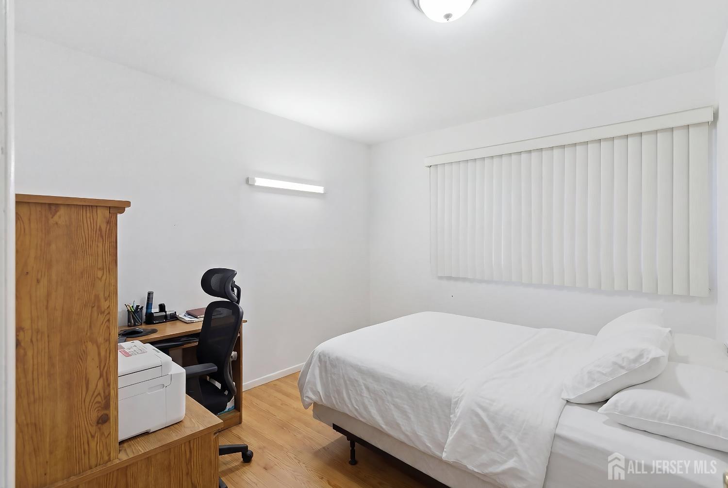 10 Cranston Road Kendall Park, NJ 08824 - Photo 17 of 27 a bedroom with a bed and wooden floor