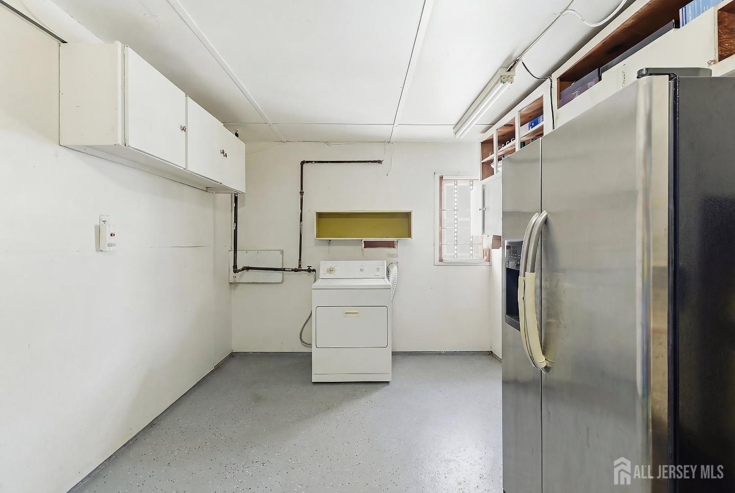 10 Cranston Road Kendall Park, NJ 08824 - Photo 21 of 27 a view of cabinets and utility room with refrigerator
