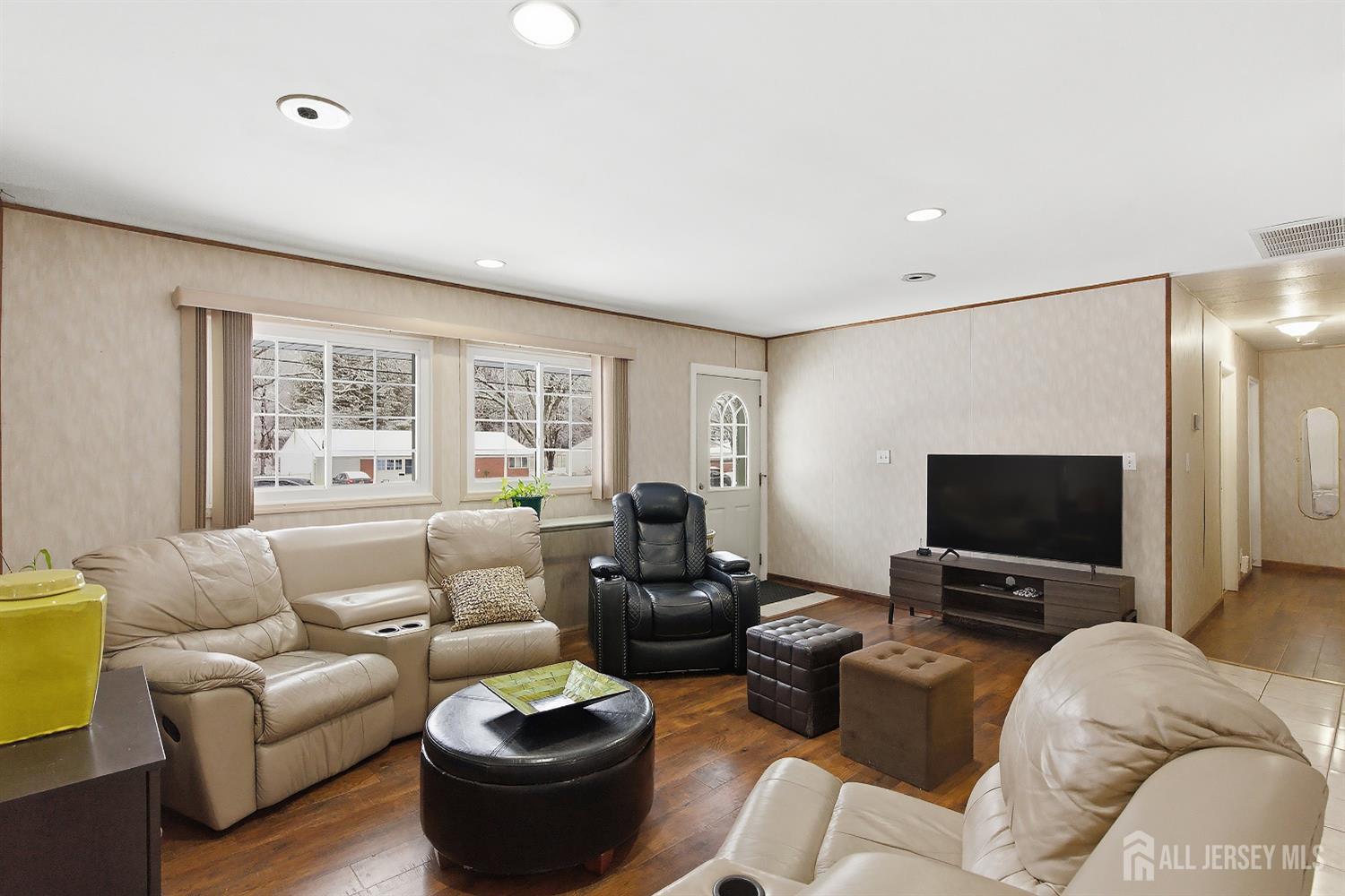 10 Cranston Road Kendall Park, NJ 08824 - Photo 6 of 27 a living room with furniture and a flat screen tv