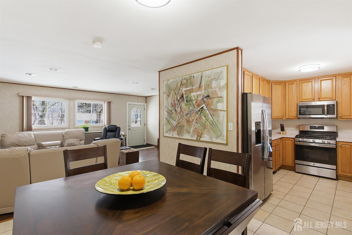 10 Cranston Road Kendall Park, NJ 08824 - Photo 7 of 27 a living room with stainless steel appliances furniture a rug and a large window