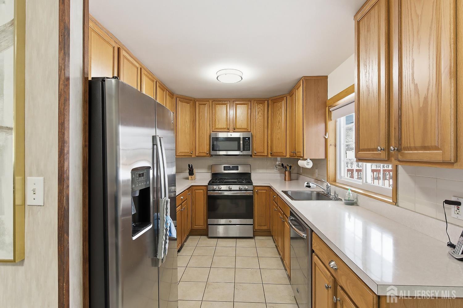 10 Cranston Road Kendall Park, NJ 08824 - Photo 10 of 27 a kitchen with a refrigerator a sink and cabinets