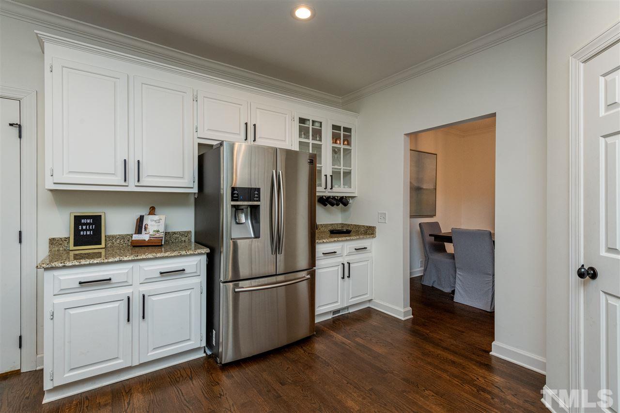 8105 Iron Bark Court Raleigh, NC 27606 - Photo 12 of 30 a kitchen with a refrigerator sink and cabinets