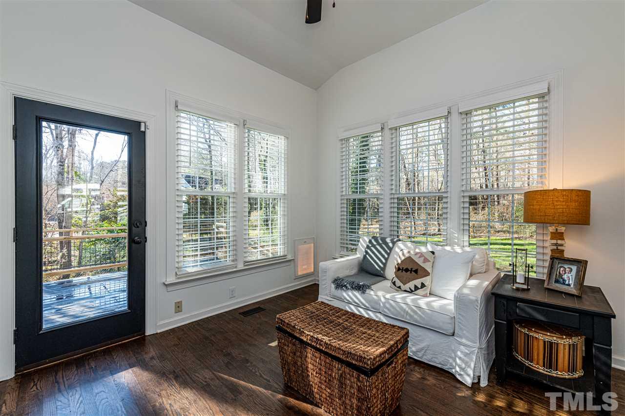 8105 Iron Bark Court Raleigh, NC 27606 - Photo 13 of 30 a living room with furniture and a floor to ceiling window