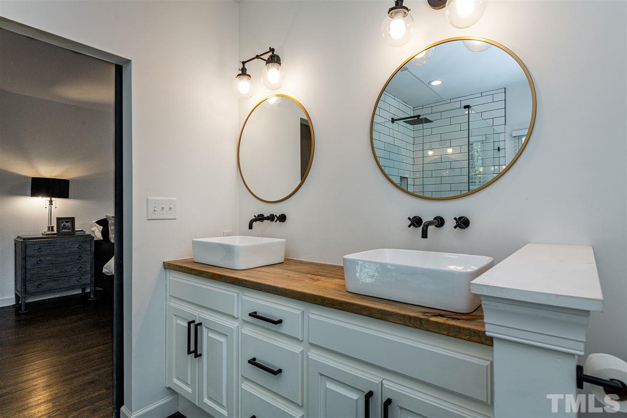 8105 Iron Bark Court Raleigh, NC 27606 - Photo 17 of 30 a bathroom with a sink and a mirror