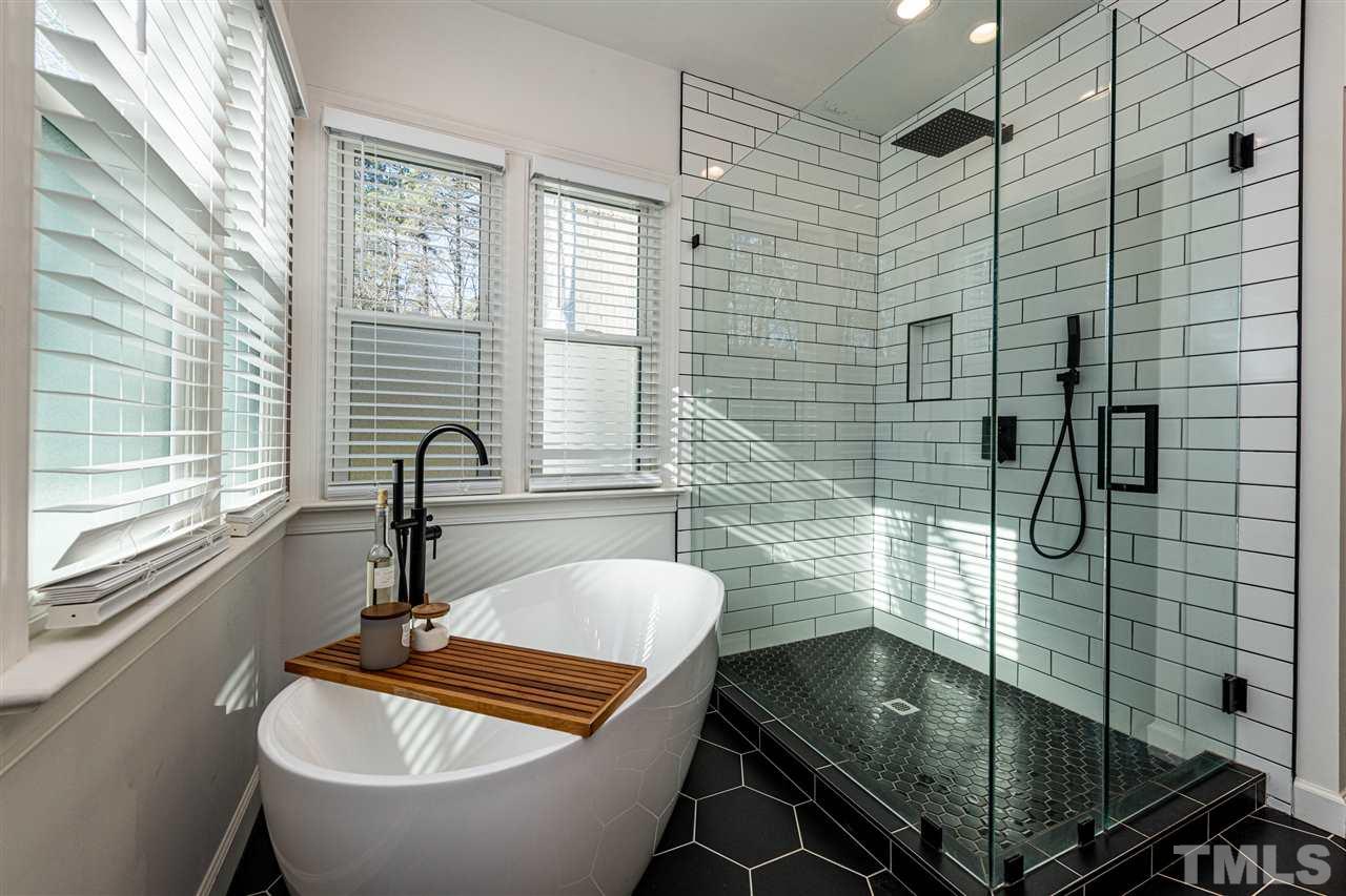8105 Iron Bark Court Raleigh, NC 27606 - Photo 18 of 30 a bathroom with a sink a bathtub and window
