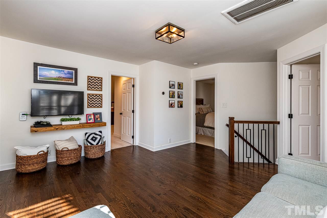 8105 Iron Bark Court Raleigh, NC 27606 - Photo 19 of 30 a living room with furniture and a flat screen tv