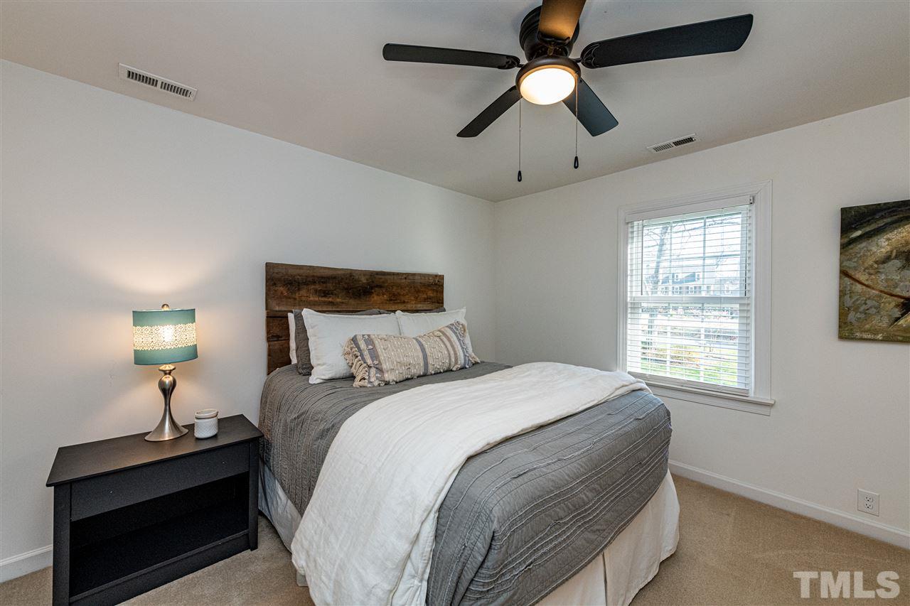 8105 Iron Bark Court Raleigh, NC 27606 - Photo 22 of 30 a bedroom with a bed and a window