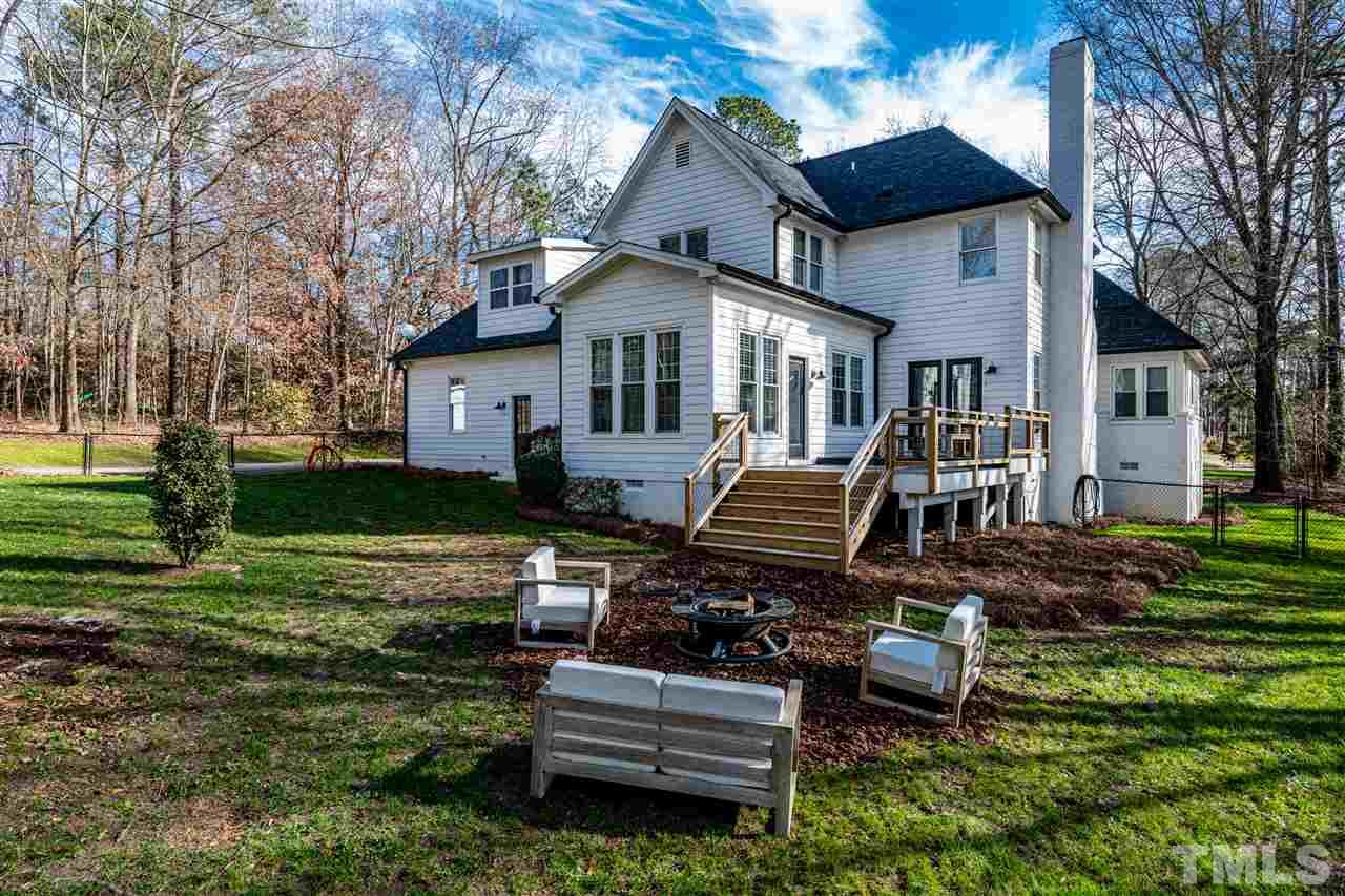 8105 Iron Bark Court Raleigh, NC 27606 - Photo 25 of 30 a front view of a house with a yard table and chairs