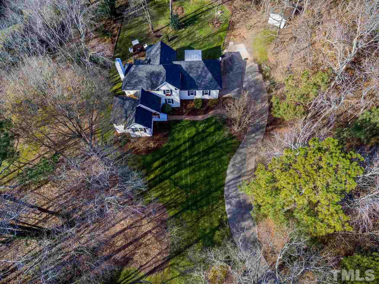 8105 Iron Bark Court Raleigh, NC 27606 - Photo 4 of 30 a view of a garden with plants and large trees