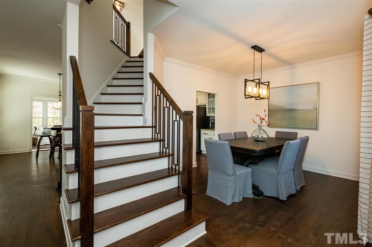 8105 Iron Bark Court Raleigh, NC 27606 - Photo 7 of 30 a view of dining room and hall with wooden floor