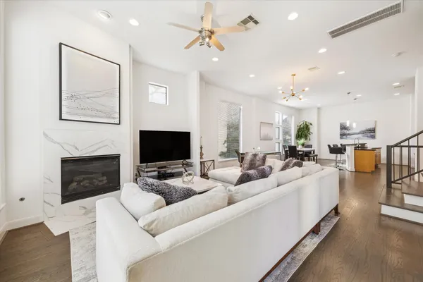 a living room with furniture a fireplace and a flat screen tv