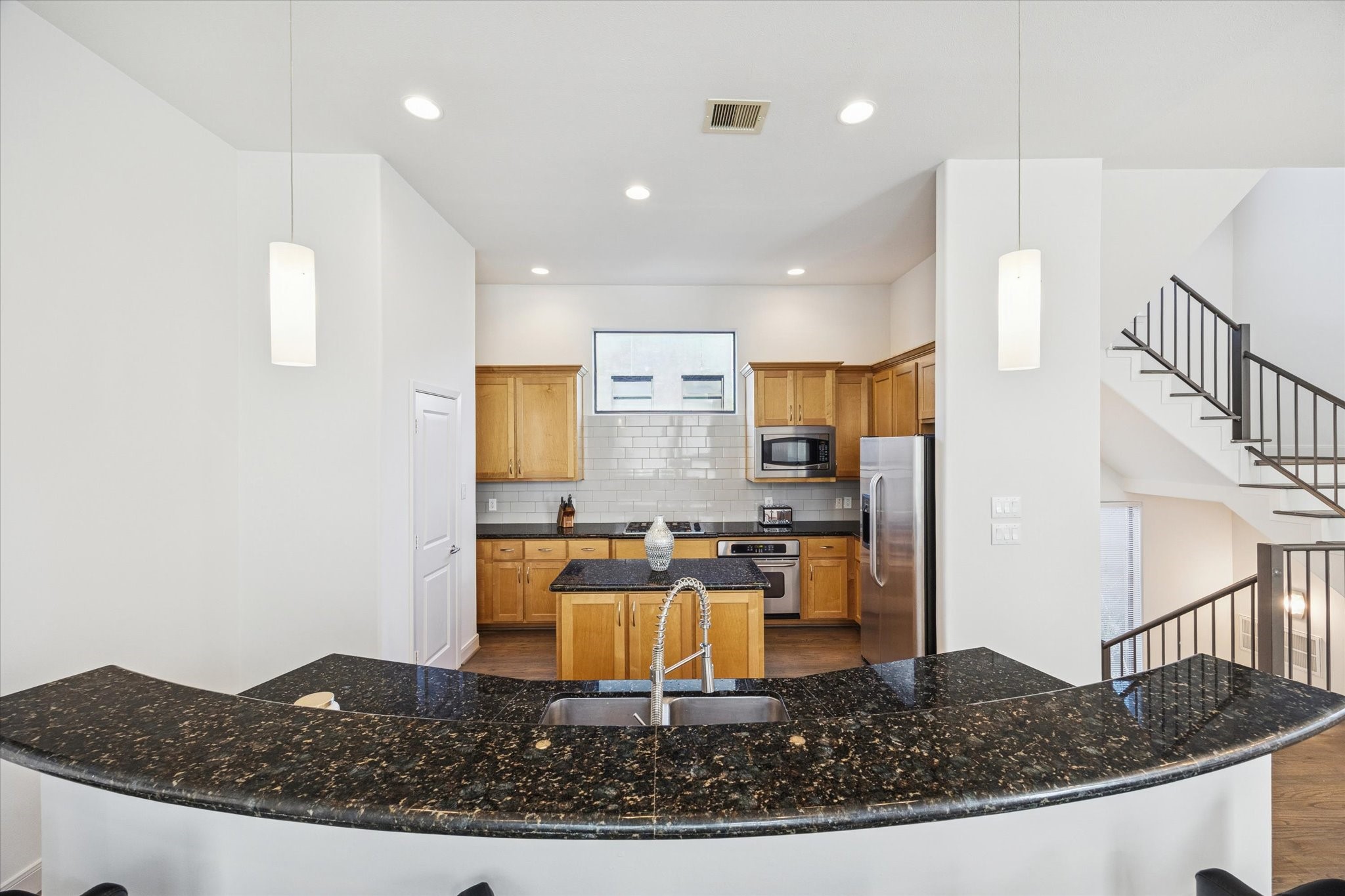 902 Roy Street Houston, TX 77007 - Photo 12 of 50 a kitchen with kitchen island granite countertop a sink a stove and a refrigerator