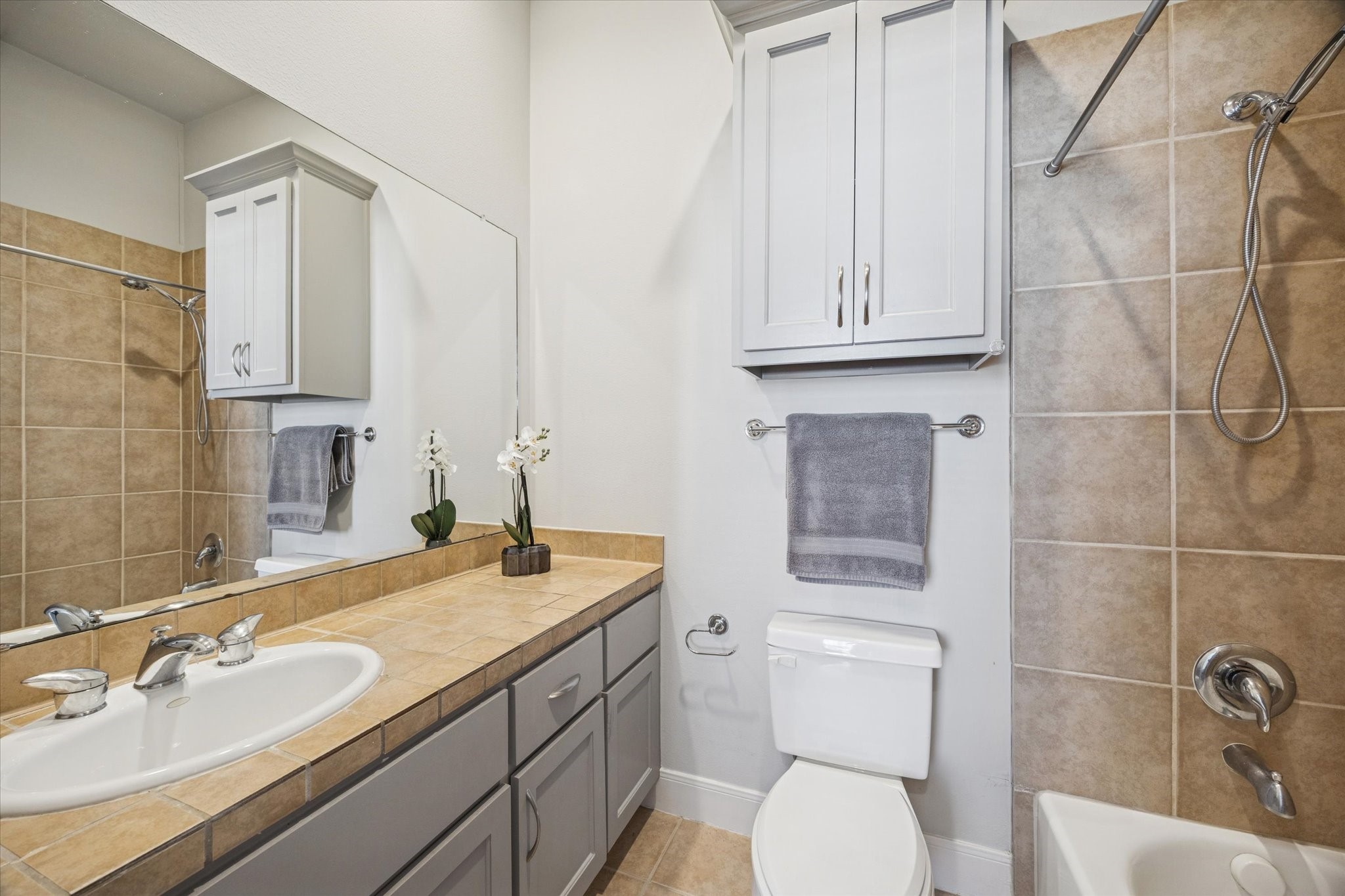 902 Roy Street Houston, TX 77007 - Photo 19 of 50 a bathroom with a granite countertop toilet sink and mirror