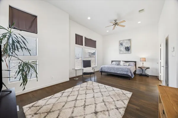 a spacious bedroom with a bed and a couch